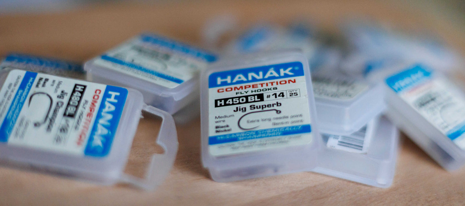 Hanak Hooks on a desk which are known for their high-performance barbless designs.