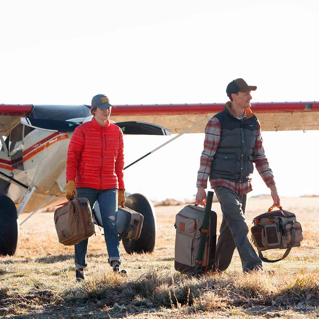 816332011245 Fishpond Green River Fly Fishing Travel and Gear Bag With Other Fishpond Travel Gear Getting Off Plane Walking