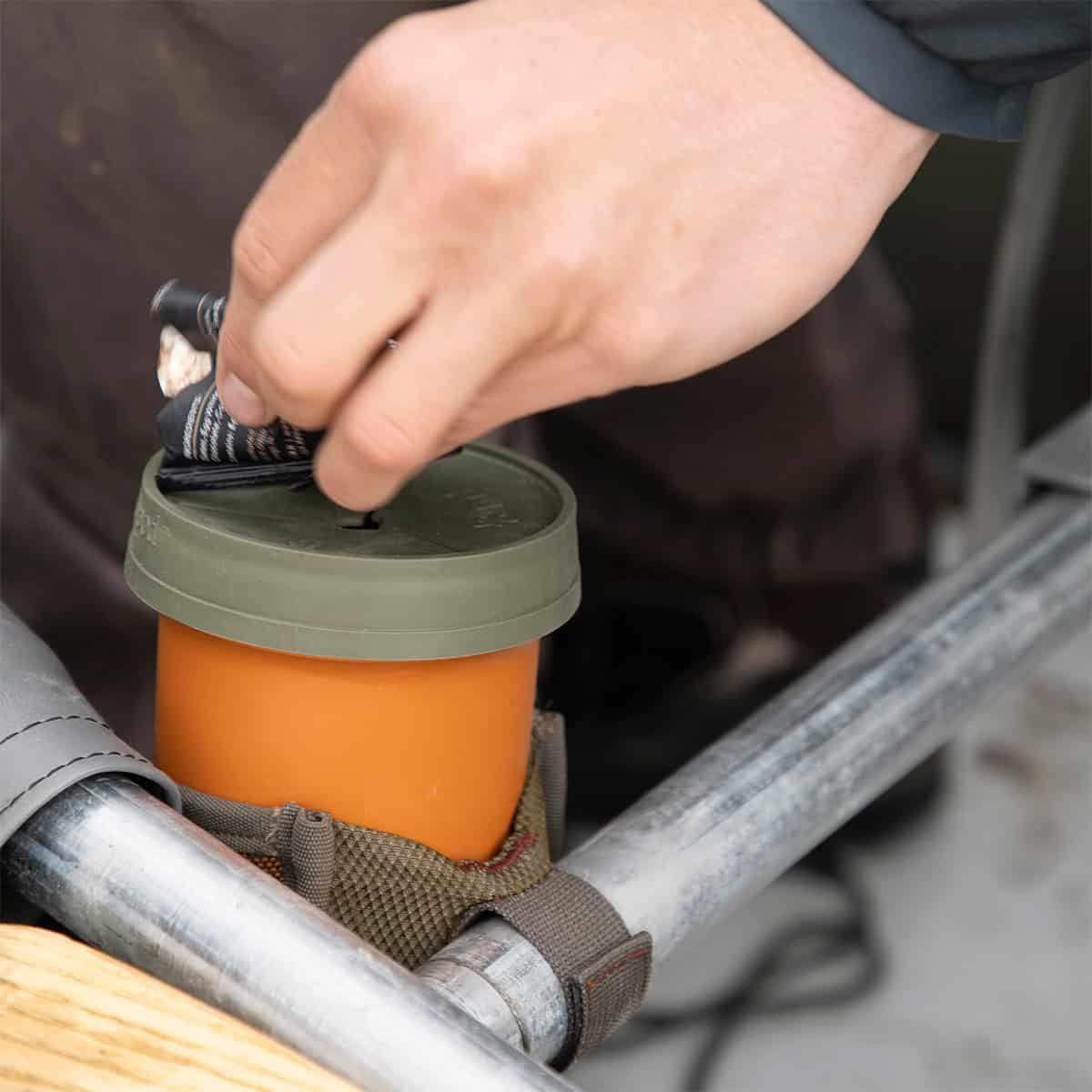 816332012105 Fishpond Largemouth PIOPOD Cutthroat Orange Micro Trash Cupholder Container On Raft Boat With Trash Alt