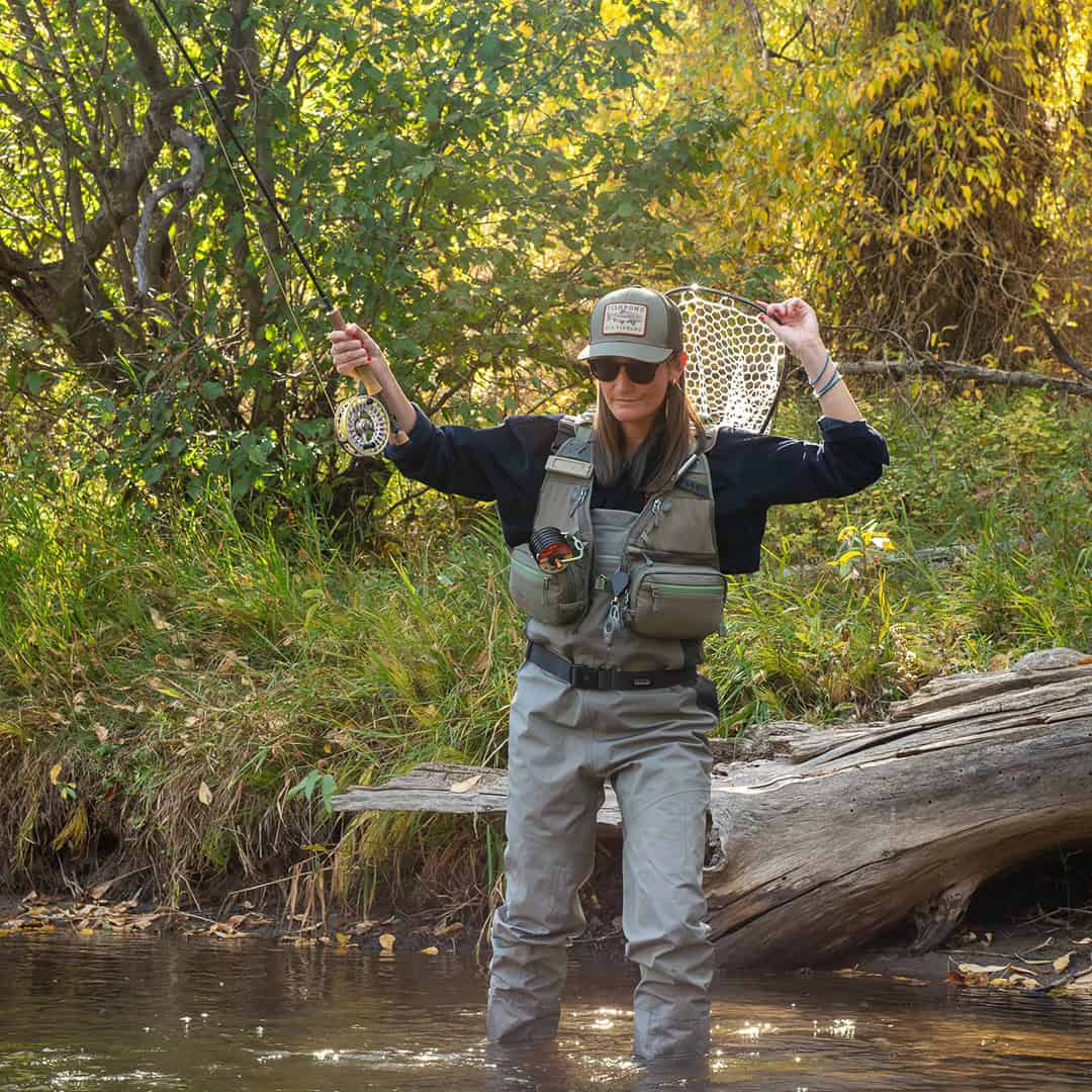 816332016790 Fishpond FlyLite Women's Fly Fishing Vest Landing A Fish