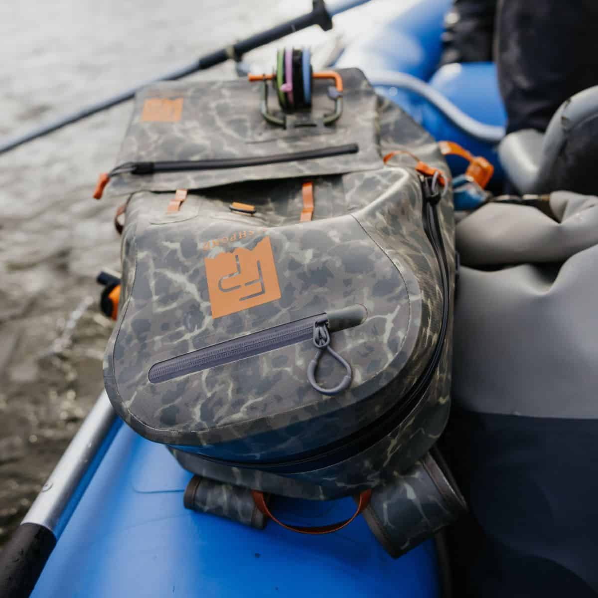 TSB-ESC 816332016332 Fishpond Thunderhead Submersible Backpack Fully Waterproof Fishing Backpack Eco Shadowcast Camo Newstream Model New 2024 Closeup On Raft