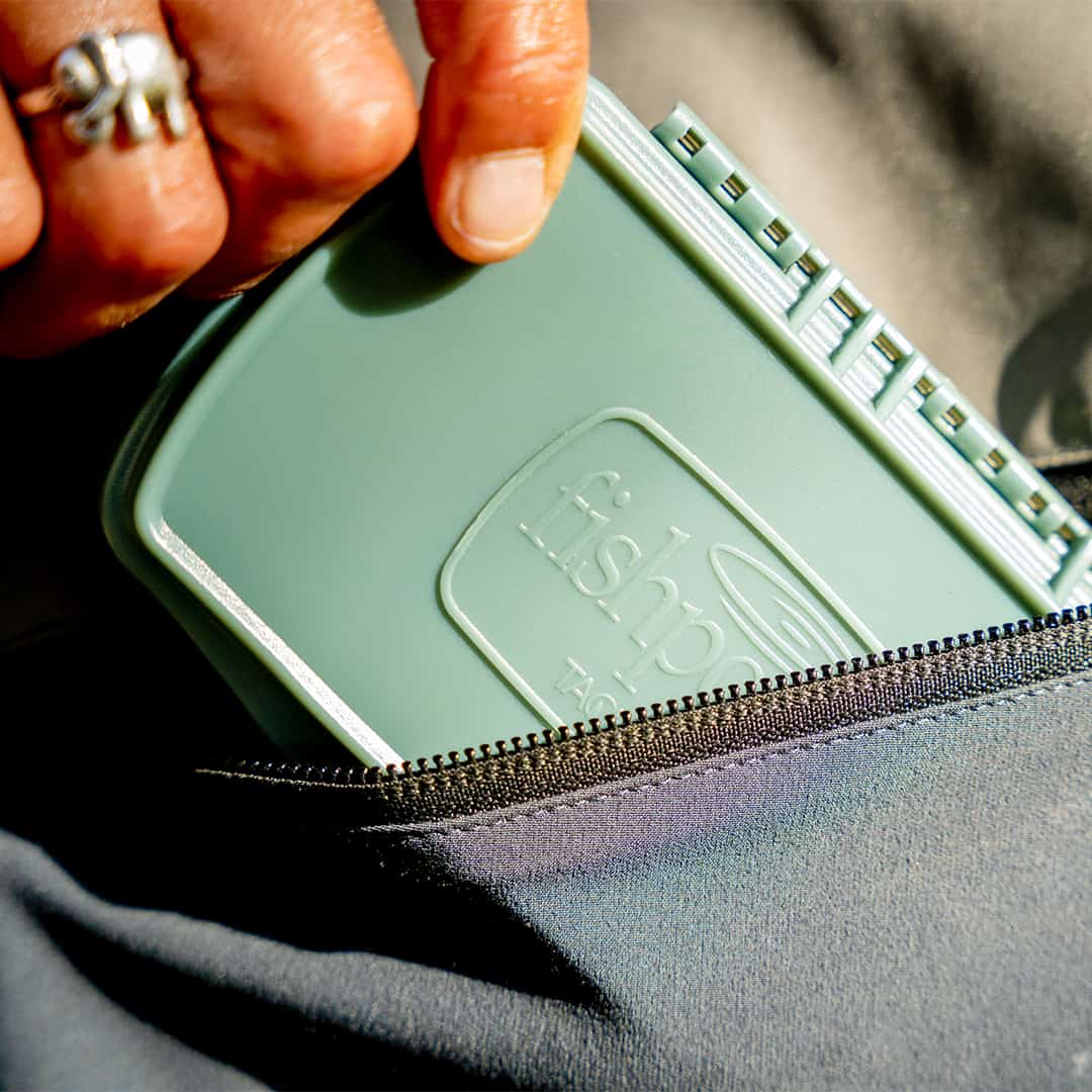 816332015632B135 TPFB-MP-S-SG Fishpond Tacky Pescador Waterproof Fly Box Small With MagPad Smoke Grey Taking Out of A Wader Pocket