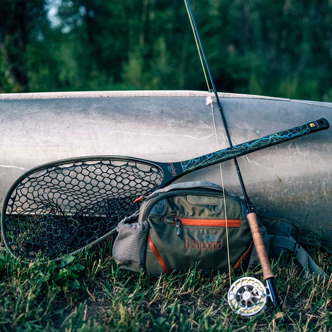 816332015694 EHLP-P Fishpond Elkhorn Lumbar Pack Pebble New Fishpond Waist Pack Front Up Against Canoe With Fly Fishing Equipment
