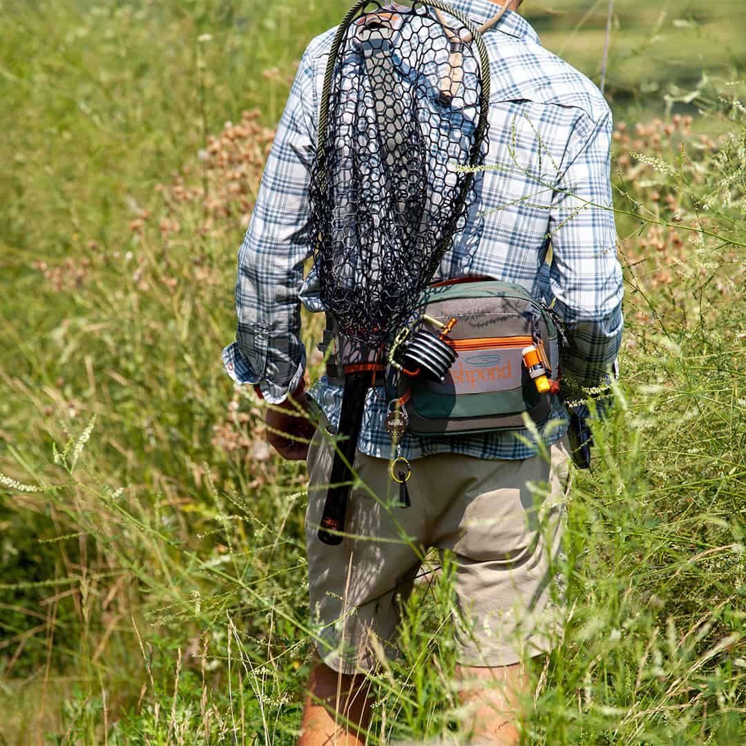      SBBS-2-0 816332014802 Fishpond Switchback 2 0 Wading Belt And Fishing Waist Pack System Walking through field
