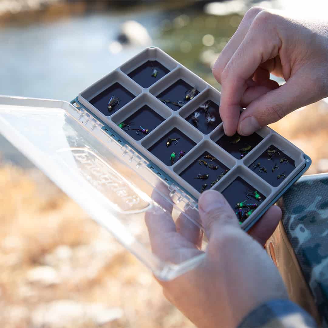 TOFB-RM-TB 816332014987 Fishpond Tacky Original Fly Box RiverMag Version Baja Blue Open On River.  Shows flies easily organized on magnet.