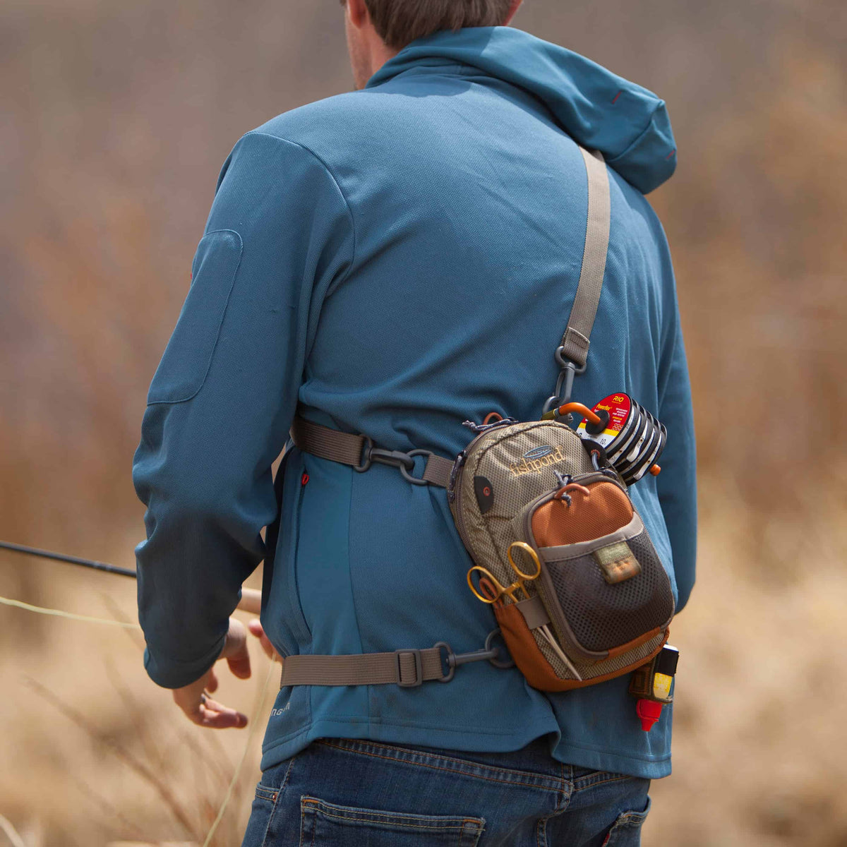 fishpond san juan vertical fishing chest pack sand and saddle brown worn as sling pack
