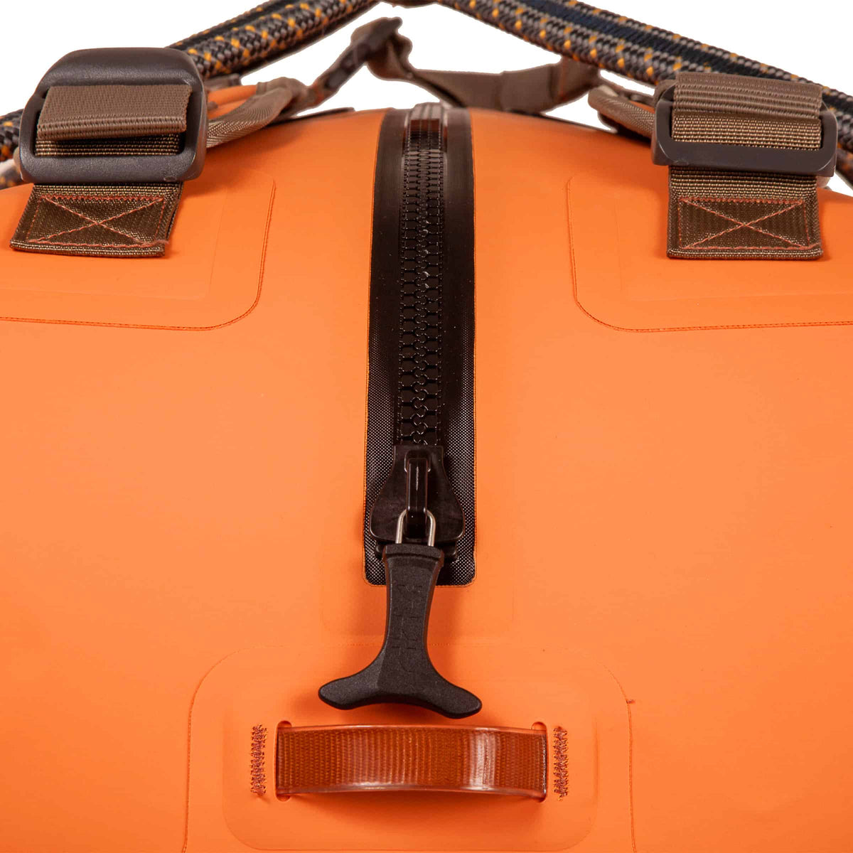 Close-up of an orange bag with black zippers and straps on a white background