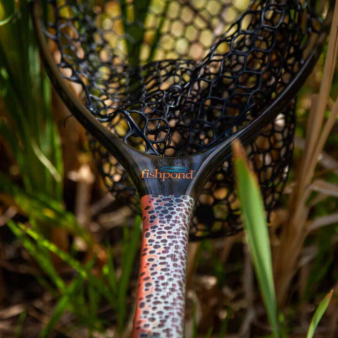 NMLN-SE 816332014925 Fishpond Nomad Mid Length Net Brown Trout Slab Limited Edition In Grass Straight On