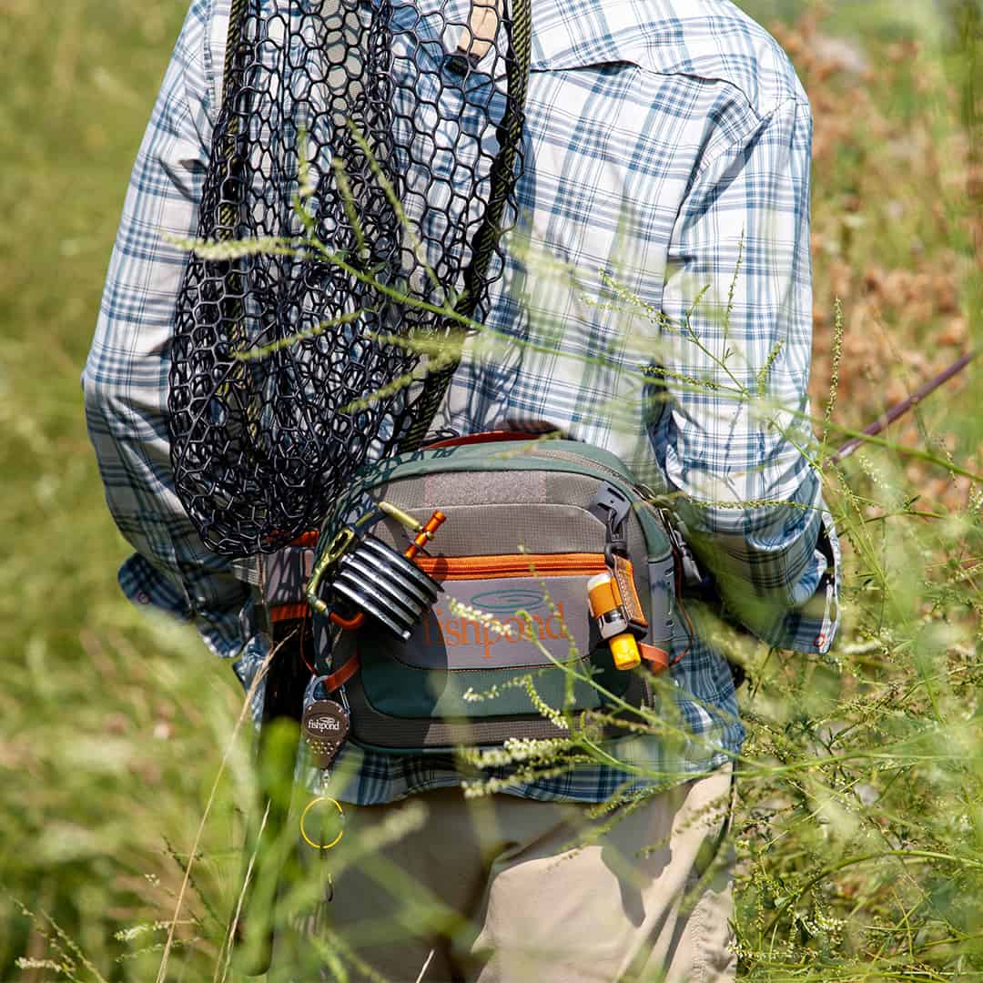      SBBS-2-0 816332014802 Fishpond Switchback 2 0 Wading Belt And Fishing Waist Pack System Walking Through A Field Detail